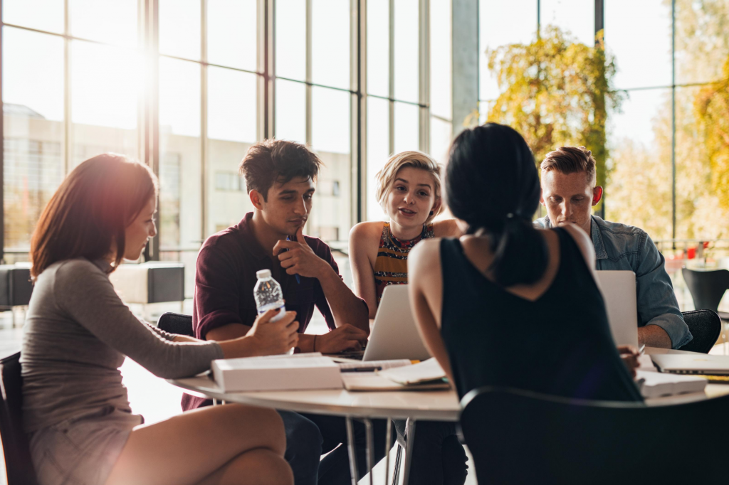 Group of students gathered at a table working on a project