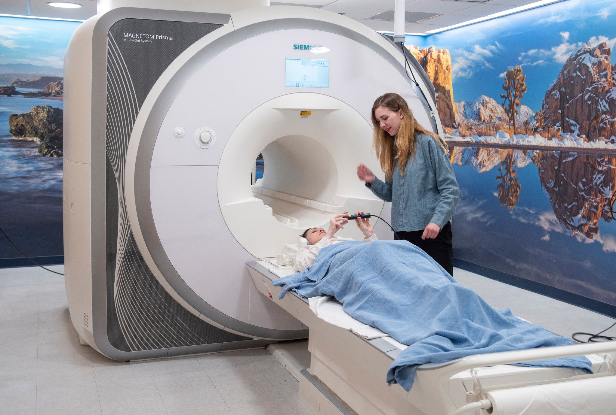 woman using MRI machine on patient